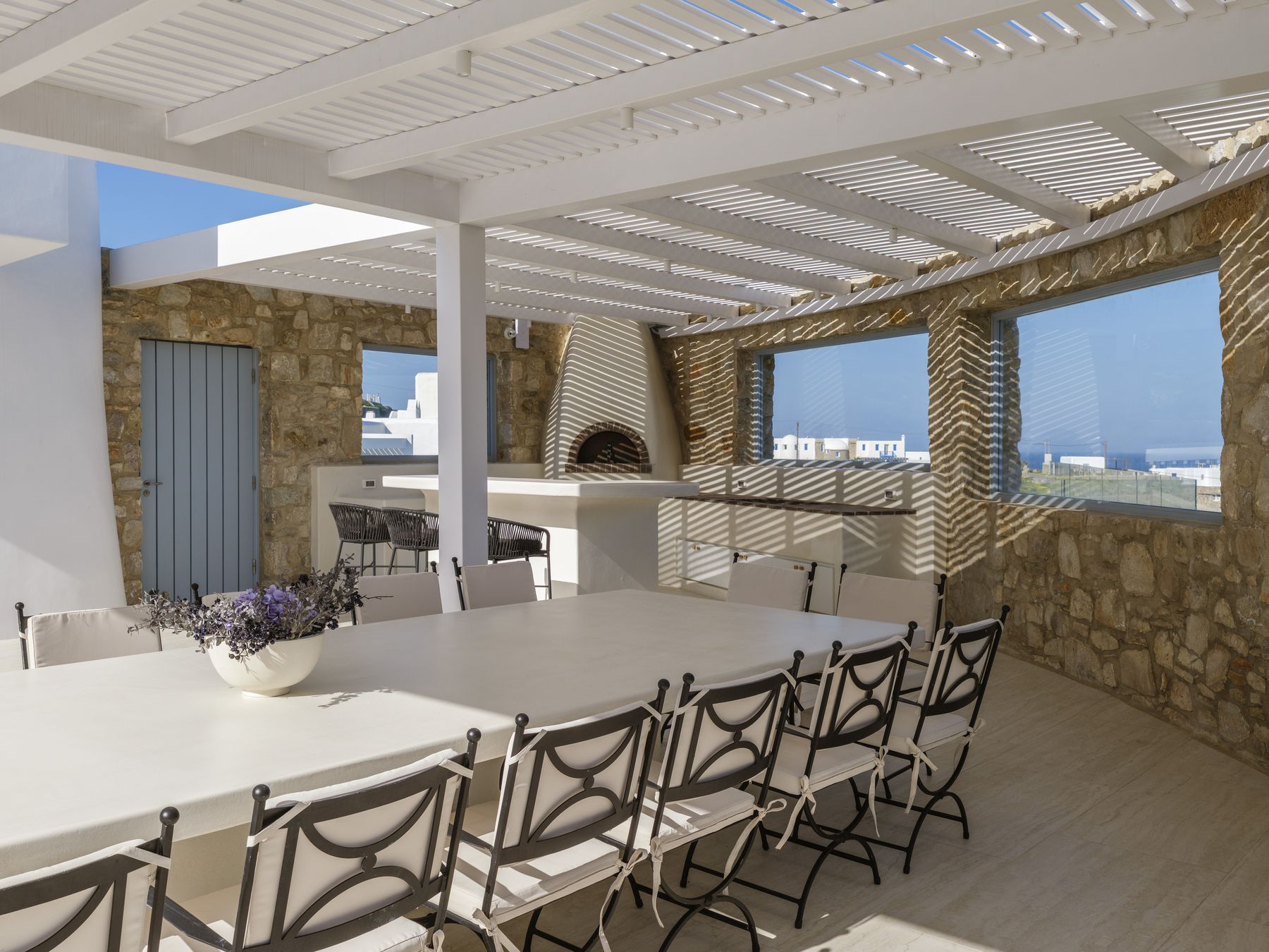Dining table with the pizza oven behind
