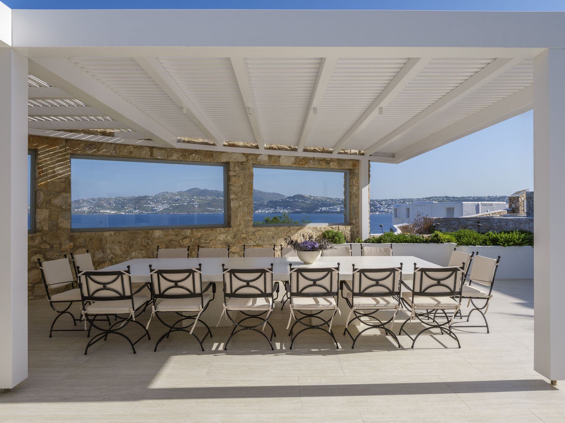 Dining table for 16 under the pergola with sea views